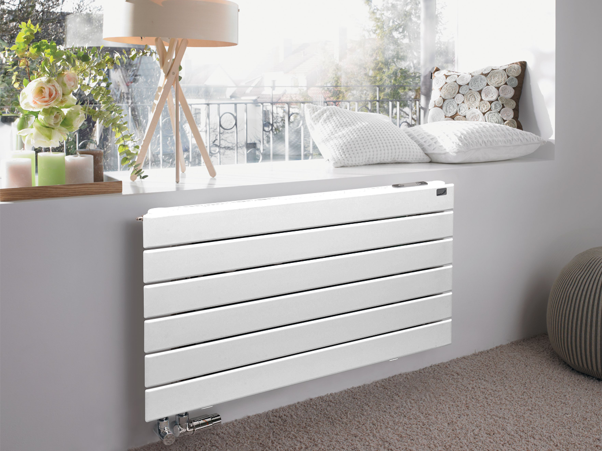 Decorative Radiators for Living Spaces White designer radiator installed beneath a sunny window in a modern living space